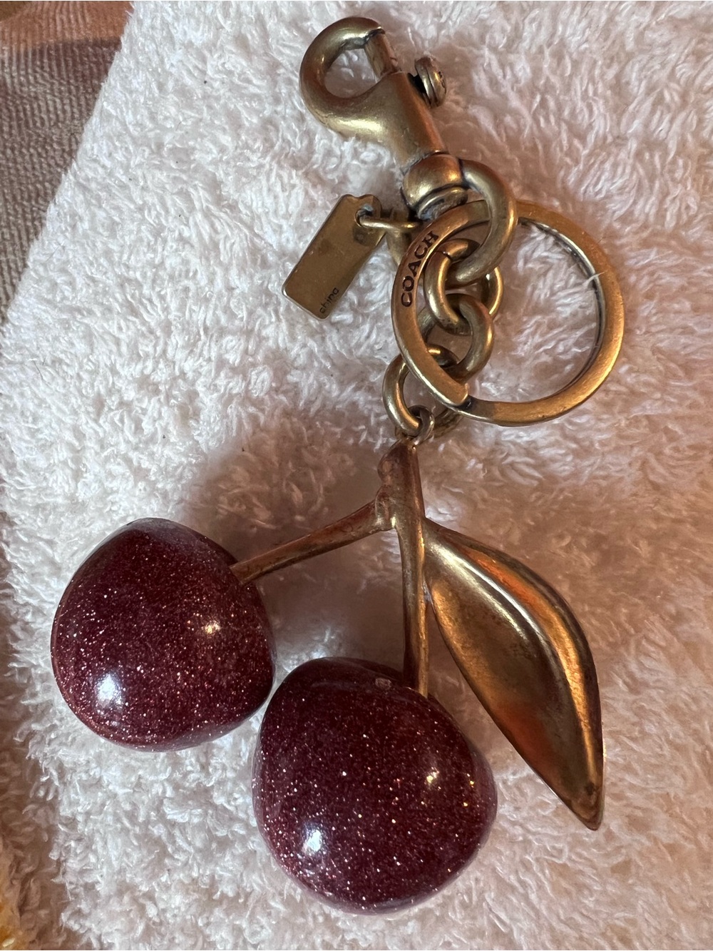 Coach Glitter Cherry Keyring in Burgundy with Gold Hardware